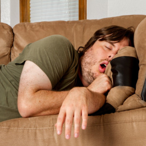 Photo of man who is meant to work from home, but is instead sleeping on the sofa