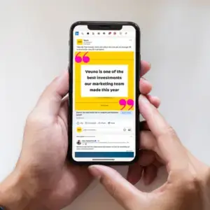 A photo of someone holding a mobile phone showing a LinkedIn ad for Veuno